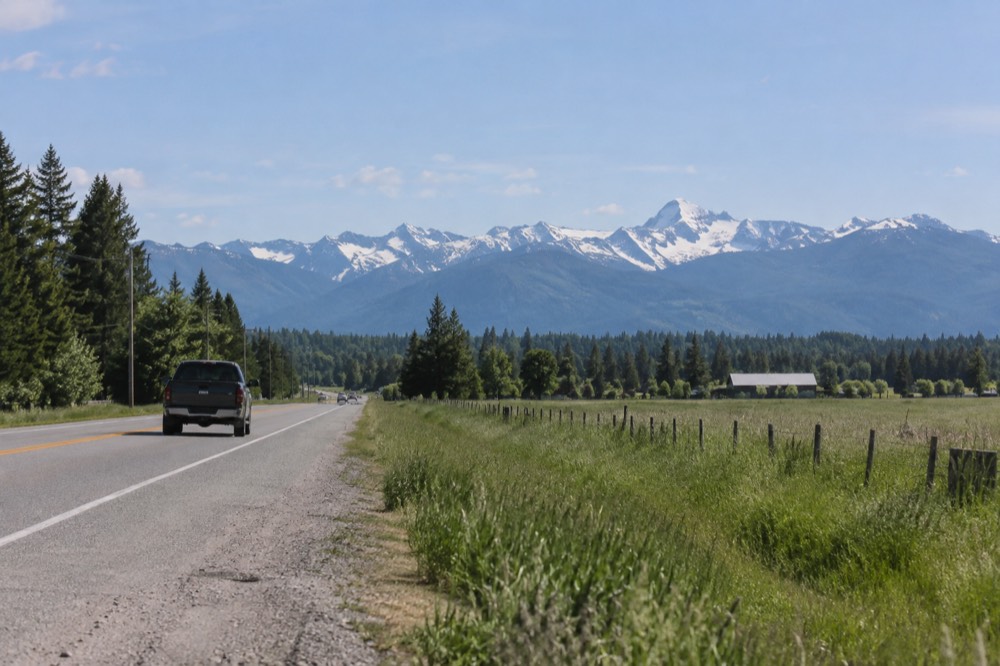 Scenic highway with mountains in the distance near Glacier National Park