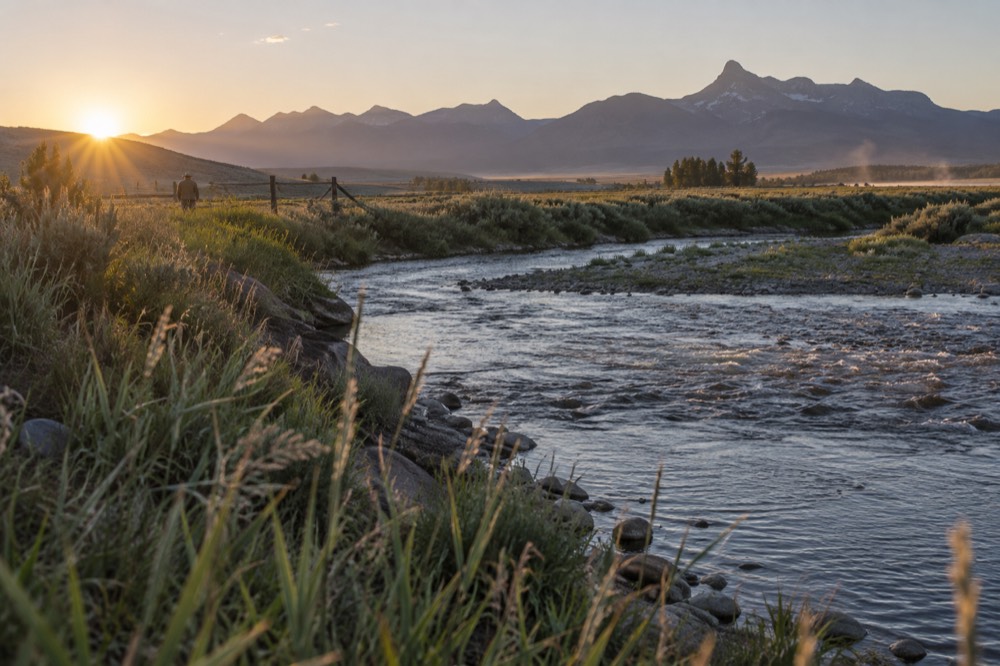Golden morning light on an open east-side valley with a winding river