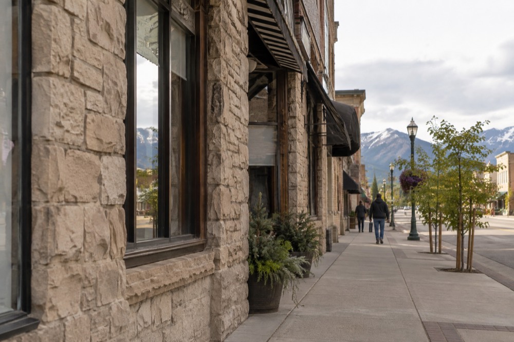 Kalispell main street with historic buildings and a mountain backdrop.